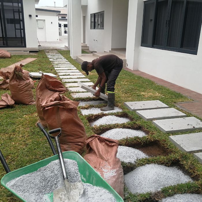 A worker installing pavers